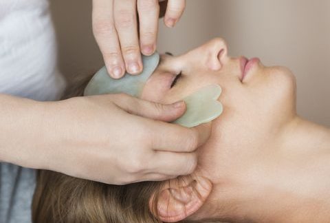 A woman is receiving a tranquil healing experience with a face mask at a spa.