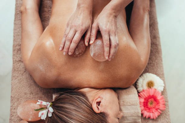 Ar Holistic Therapy - Bradford - Experience the power of touch as a woman enjoys a relaxing back massage at a luxurious spa.