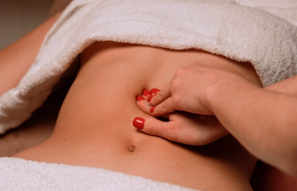 Ar Holistic Therapy - Bradford - Experience the power of touch as a woman receives a relaxing stomach massage.