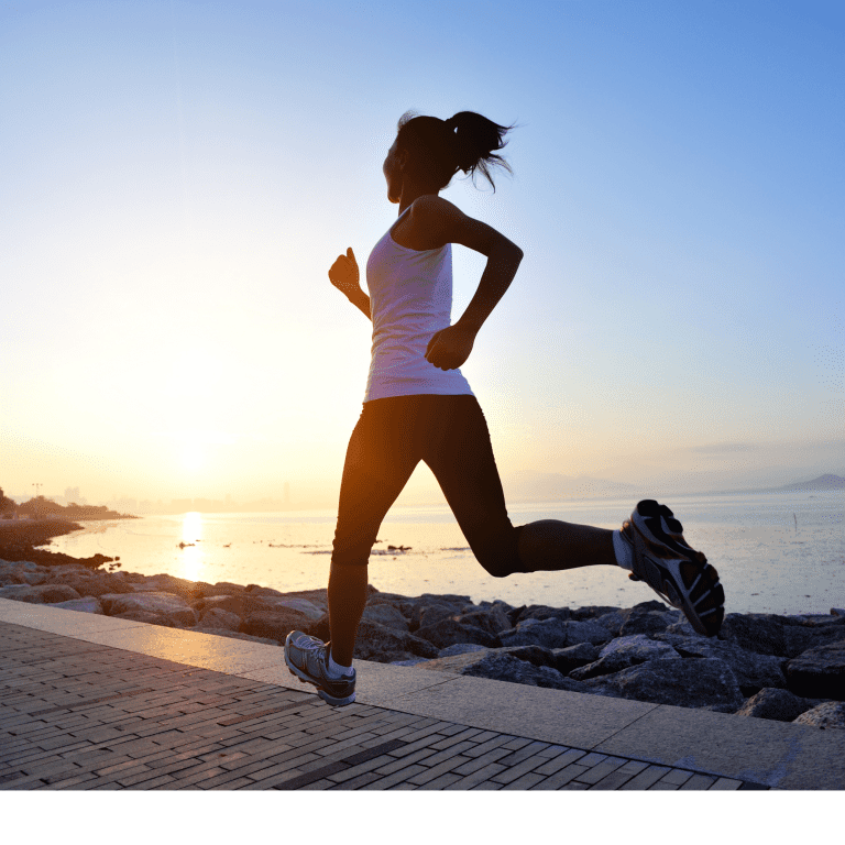 Ar Holistic Therapy - Bradford - A woman engaging in healthy living by jogging at sunset.