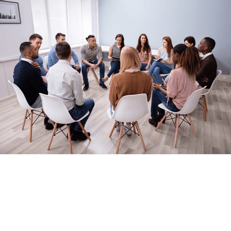 Ar Holistic Therapy - Bradford - A group of people sitting in a circle in an office, engaging in a discussion about morality.