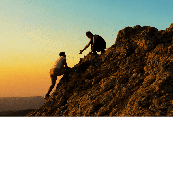 Ar Holistic Therapy - Bradford - Two people with innate capability climbing a mountain at sunset.