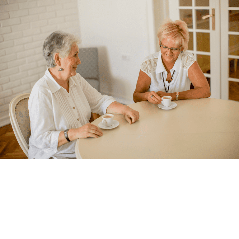 Ar Holistic Therapy - Bradford - Two elderly women, mesmerized by the power of words, sitting at a table.