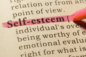 Ar Holistic Therapy - Bradford - Close-up of a dictionary entry for "self-esteem" highlighted in pink.