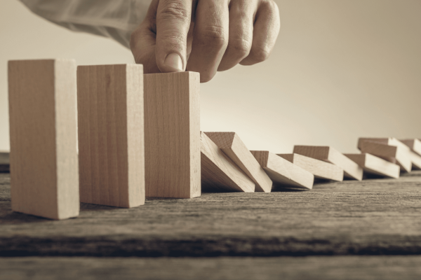 Ar Holistic Therapy - Bradford - A man is arranging wooden blocks on a wooden table, unaware of the potential consequences.