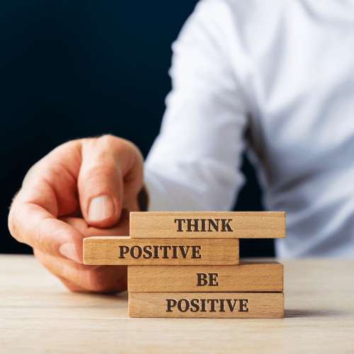 Ar Holistic Therapy - Bradford - A man holding a stack of wooden blocks promoting positivity.