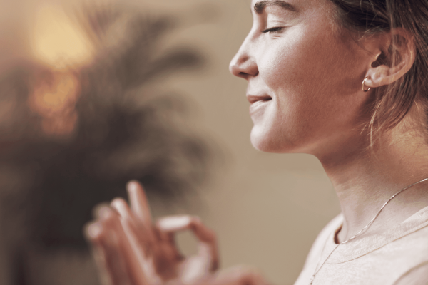 Ar Holistic Therapy - Bradford - A woman meditating in front of a window, seeking personal growth.