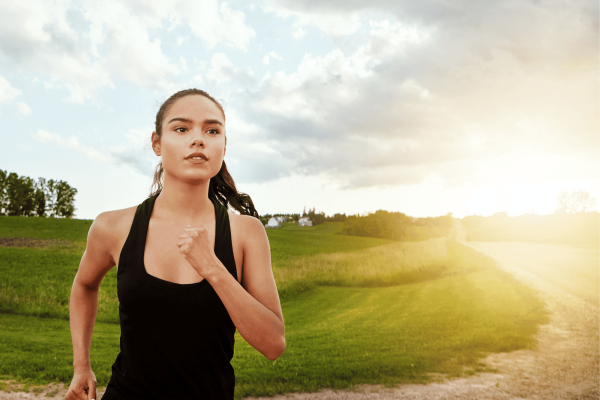 Ar Holistic Therapy - Bradford -         A woman jogging on a dirt road by herself.